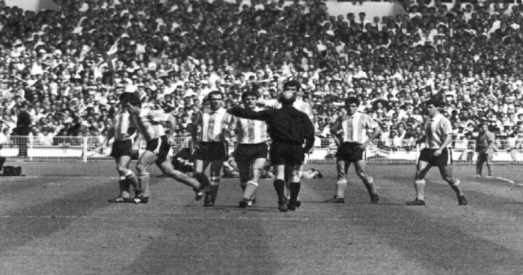 West German referee Rudolf Kreitlein tries to pacify angry Argentine players after sending off teammate Antonio Rattin during the 1966 World Cup quarterfinal